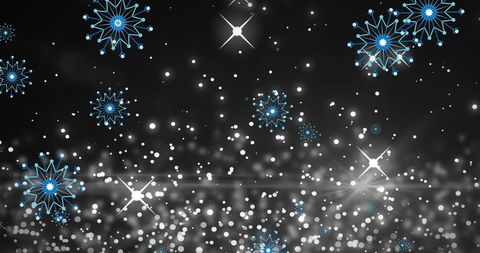 Festive blue snowflakes on glowing night background