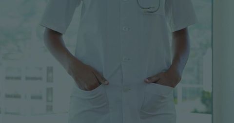 Female doctor in lab coat with stethoscope in modern medical setting