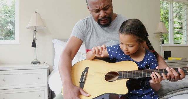 Father Teaching Daughter to Play Guitar at Home - Download Free Stock Images Pikwizard.com