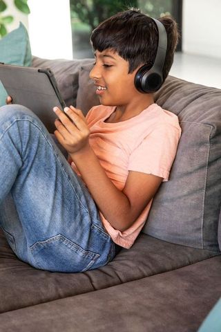 Young Boy Enjoying Tablet with Headphones at Home