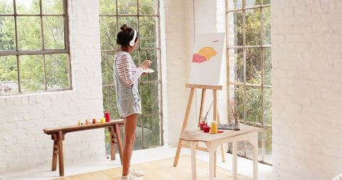 Creative Asian Woman Painting Abstract Art in Studio
