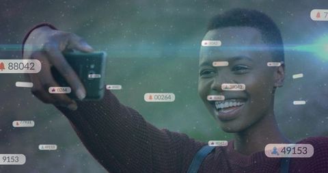 Smiling creator capturing selfie with social media interaction icons