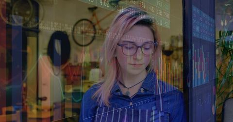 Craftswoman analyzing digital data in rustic workshop