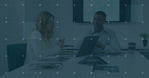 Colleagues Collaborating Over Laptop in Modern Meeting Room