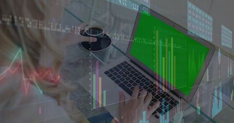 Businesswoman Analyzing Financial Data on Laptop in Modern Setting