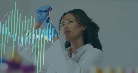 Female scientist examining blood vial while analyzing digital data overlay in clinical lab