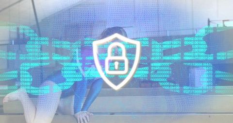 Hooded woman guarding privacy with glowing shield lock overlay, cybersecurity concept
