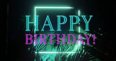 Neon birthday sign with glowing tropical palm leaves