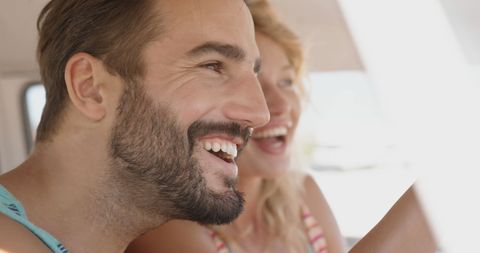 Happy Couple Enjoying Beach Vacation in Campervan