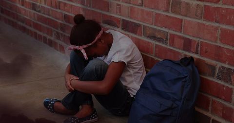 Sad Schoolgirl Sitting Alone Near Brick Wall Reflecting Bullying - Download Free Stock Images Pikwizard.com