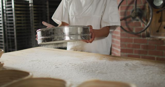 Baker Sifting Flour in Industrial Bakery - Download Free Stock Images Pikwizard.com