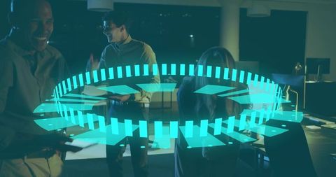 Business team collaborating around holographic circular interface in dim office at night