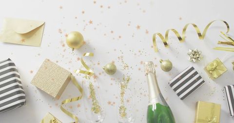Green Champagne and Gold Confetti Flatlay Featuring Gifts, Ribbons and Toasting Flutes