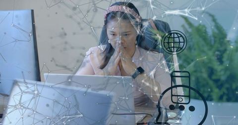 Mid Adult Woman Analyzing Data at Office Desk with Technology Overlay