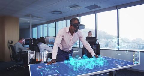 Man in vr headset interacting with holographic display in modern office