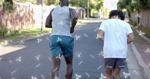 Two men running on neighborhood street wearing athletic gear with reflective trim