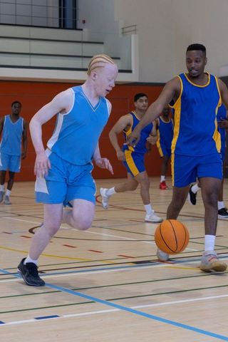 Diverse Basketball Game in Action on Indoor Court