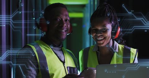 African american technicians in server room with digital interface