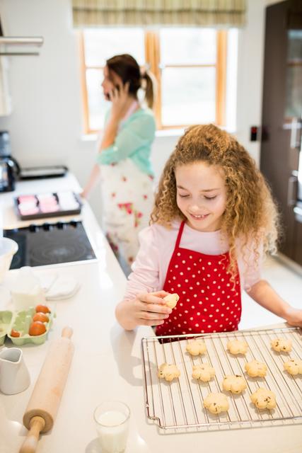 Girl eating cookies in kitchen - Download Free Stock Photos Pikwizard.com
