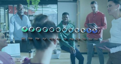 Diverse Team Collaborating Over Annual Data with Laptops