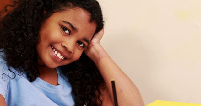 Smiling Girl with Curly Hair Relaxing Inside - Download Free Stock Images Pikwizard.com