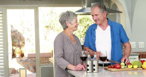 Senior Couple Bonding in Kitchen While Preparing Meal