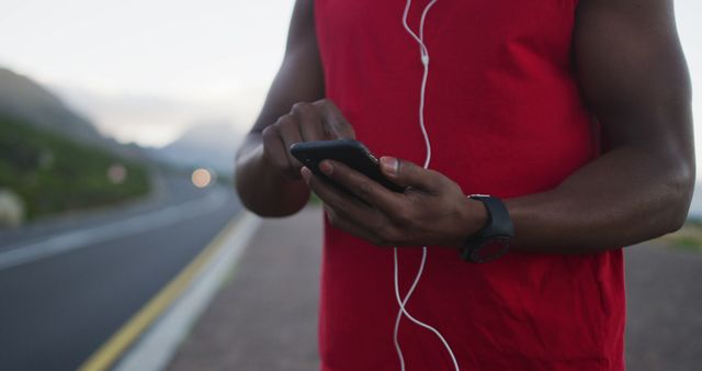 Athletic Person Using Smartphone During Outdoor Jog - Download Free Stock Images Pikwizard.com