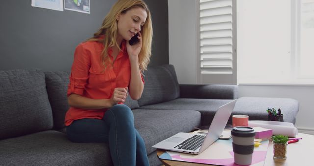 Woman Talking on Phone While Working on Laptop at Home - Download Free Stock Images Pikwizard.com