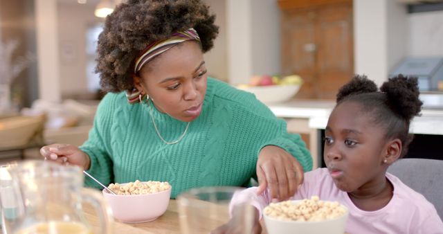 Mother and Daughter Enjoying Breakfast with Cereal - Download Free Stock Images Pikwizard.com