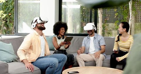 Diverse Friends Using VR and Mobile Technology in Cozy Living Room