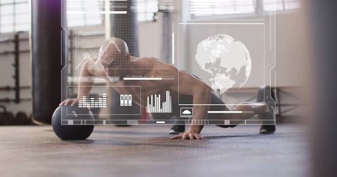 Shirtless athlete performing one-arm pushup on medicine ball with fitness data hud