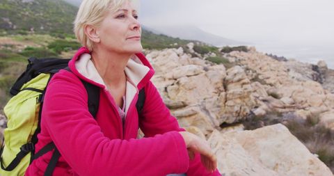 Senior Woman Trekking Peacefully Through Mountainous Terrain