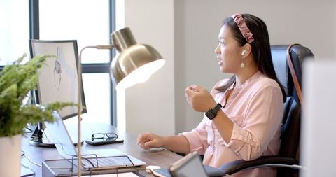 Businesswoman Engaging in Virtual Meeting via Laptop