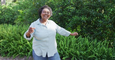 Elderly Woman Dancing Joyfully in Garden