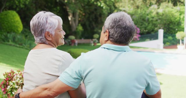 Image of back view of biracial senior couple embracing in garden. active retirement lifestyle, senior relationship and spending time together concept.