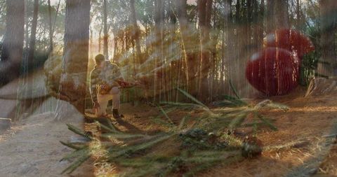 Kneeling man in golden pine forest double exposure showing camouflage gear and sunbeams