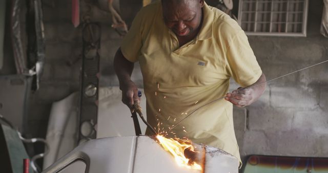 Man Welding Metal in Workshop With Sparks Flying - Download Free Stock Images Pikwizard.com