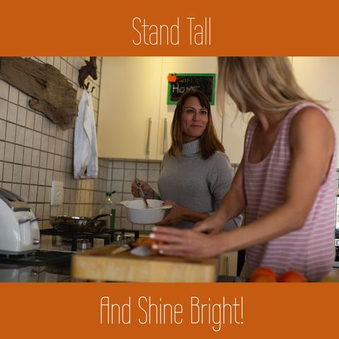 LGBTQ Couple Cooking Together in Kitchen with Motivational Text