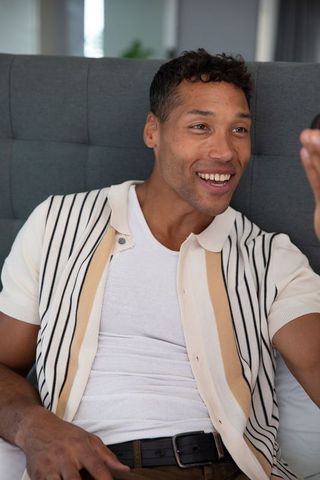 Smiling Man Taking Selfie While Seated at Home by Window