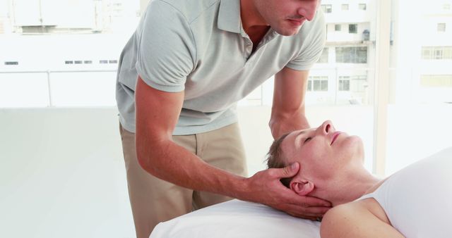Professional therapist performing a manual chiropractic adjustment on a female patient. Image is showing the therapist's hands gently manipulating the neck area while the patient lies relaxed on a medical table. Useful for illustrating chiropractic services, wellness brochures, medical blogs, or health-focused websites to highlight physical therapy, rehabilitation, and recovery processes.
