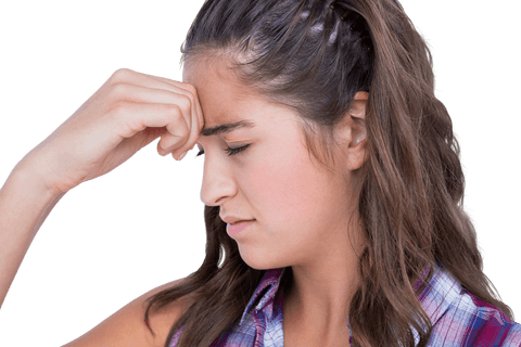 Young woman holding her forehead with eyes closed, expressing pain. Hand covers forehead, showing discomfort caused by headache or stress. Ideal for conveying health-related themes such as mental health, stress, headache relief. Could be used in promotional content for wellness products or articles about dealing with migraines or emotional stress.
