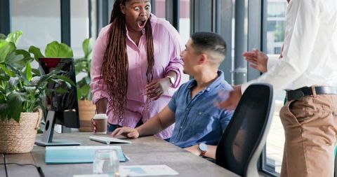 Excited Colleagues Celebrating Success in Modern Office Environment