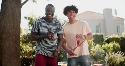 Diverse Male Friends Enjoying Summer Backyard Barbecue