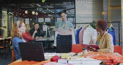 Team style review at modern fashion studio with designers