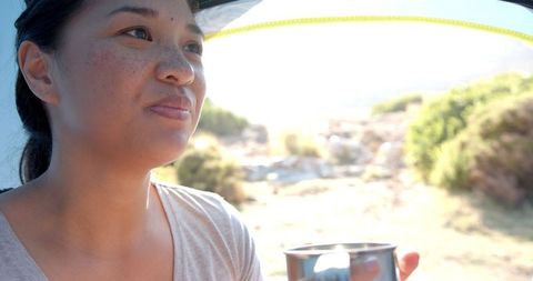 Woman drinking water and enjoying mountain adventure