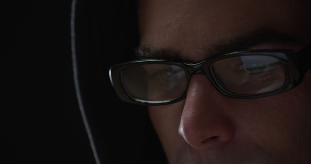 Young Man in Hoodie and Glasses Focused on Laptop Screen - Download Free Stock Images Pikwizard.com