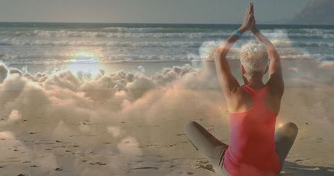 Senior Female Meditating with Ocean View at Peaceful Beach