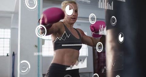 Female boxer training with performance hud overlays and fitness analytics in modern gym
