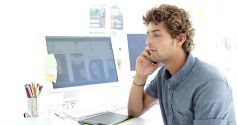 Creative Designer Talking on Phone in Modern Office - Download Free Stock Images Pikwizard.com