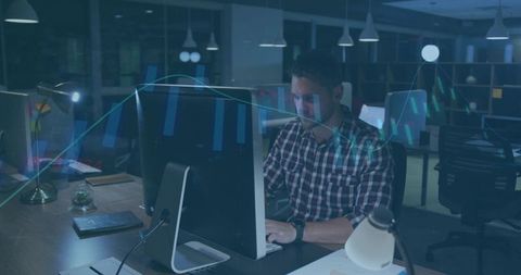 Man working late in office with trading chart overlay and financial data visualization